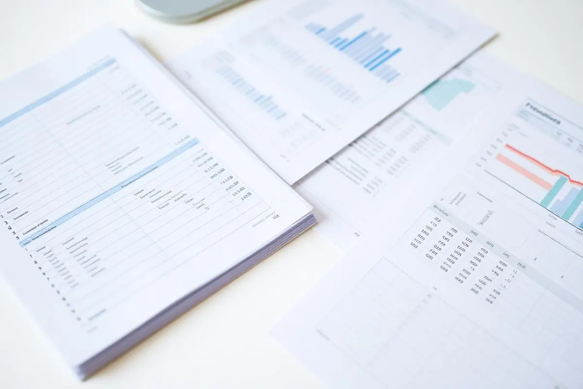 Organized financial statements and ledgers arranged on a bright desk